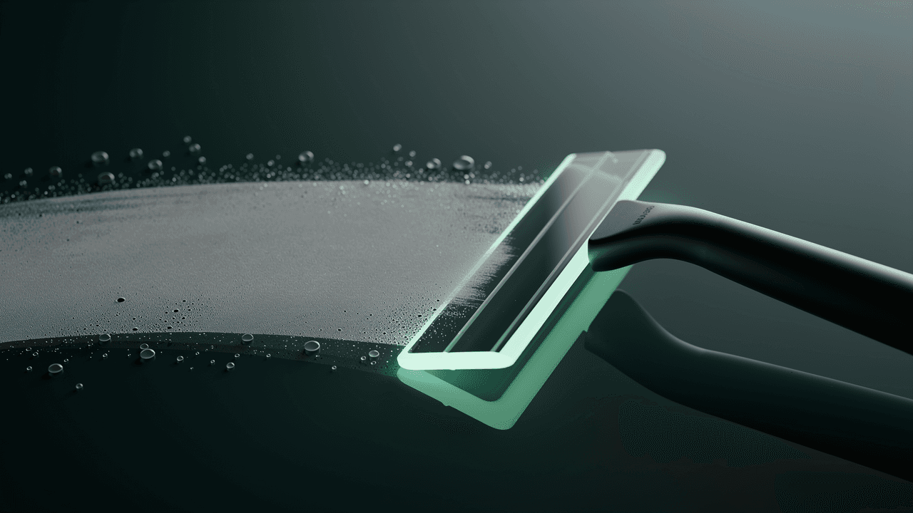 A blade wiping condensation off dark glass, leaving it clean